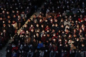 TOPSHOT - This picture taken on February 23, 2020 shows audience members wearing face masks at a J.League football match between Vissel Kobe and Yokohama F. Marinos in Kobe. - The Japanese government has urged people to avoid large gatherings, and Tokyo's government has cancelled some large public events over COVID-19 coronavirus fears that has now killed more than 2,400 people and spread around the world. (Photo by STR / JIJI PRESS / AFP) / Japan OUT (Photo by STR/JIJI PRESS/AFP via Getty Images)