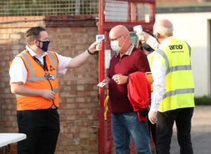 CAMBRIDGE, ENGLAND - SEPTEMBER 08: A member of staff has his temperature taken ahead of the EFL Trophy match between Cambridge United and Fulham U23 at Abbey Stadium on September 08, 2020 in Cambridge, England. Cambridge United are allowing limited number of spectators (1000) to be in attendance as covid 19 pandemic restrictions are eased. (Photo by Catherine Ivill/Getty Images)